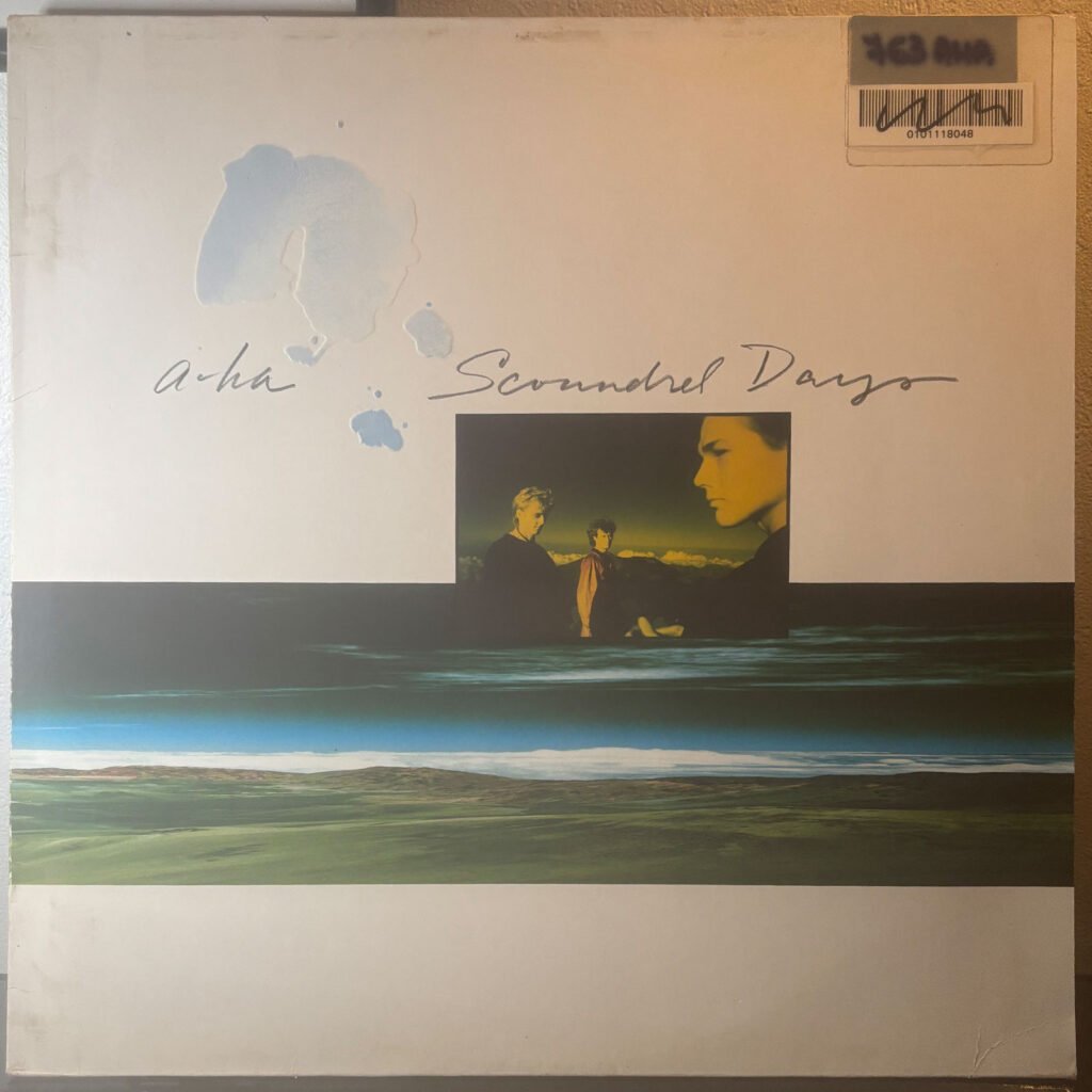 Front sleeve of a-ha — Scoundrel Days, Simon Morgan's copy with library barcode sticker.