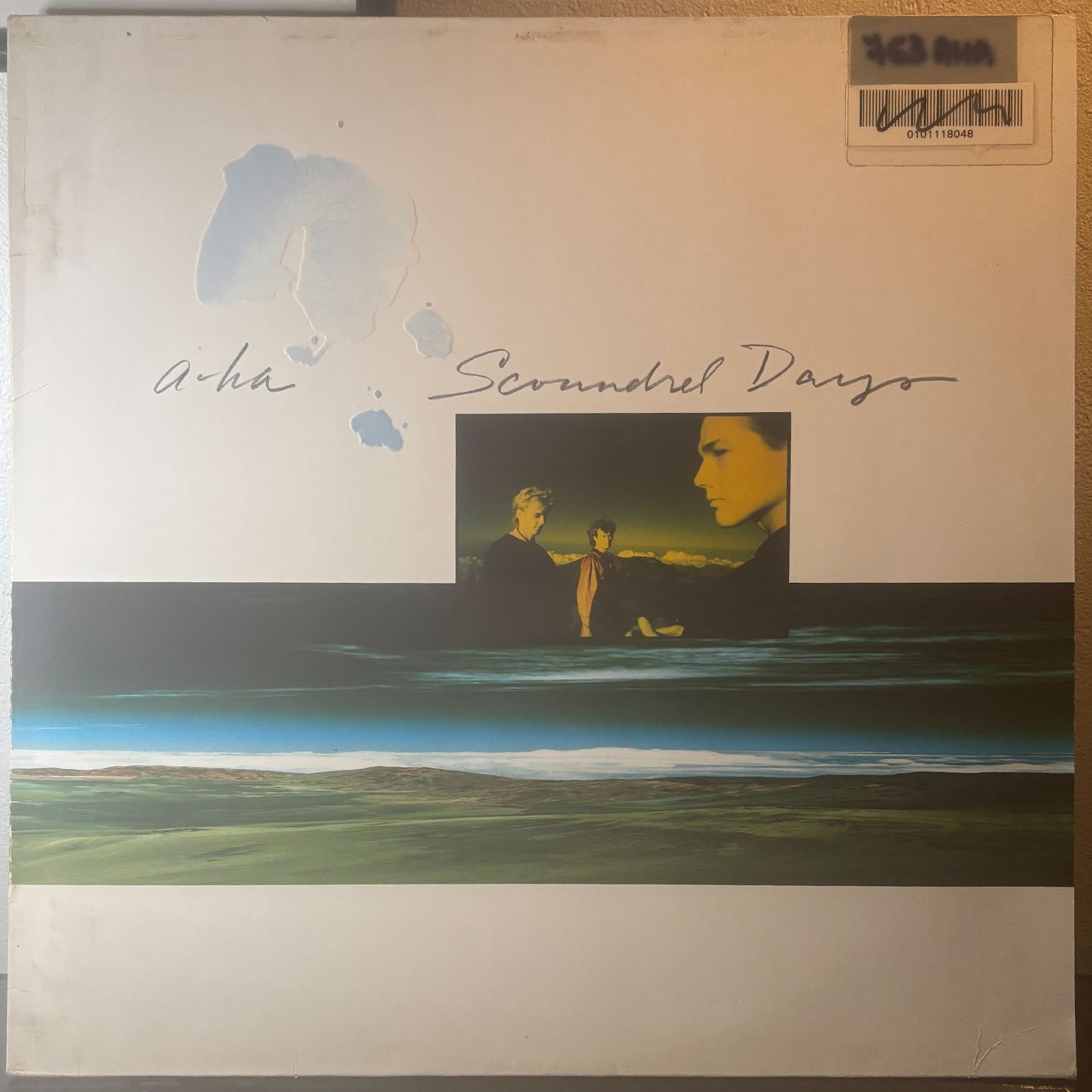 Front sleeve of a-ha — Scoundrel Days, Simon Morgan's copy with library barcode sticker.